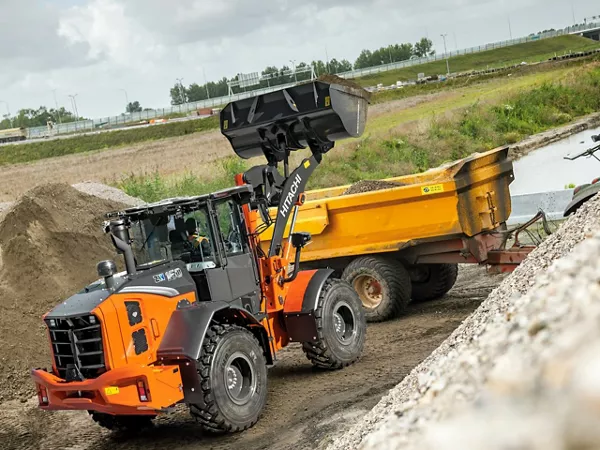 Hitachi-ZW160 scooping up dirt.